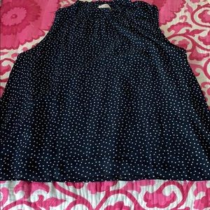 Sleeveless navy blue top with white polka dots